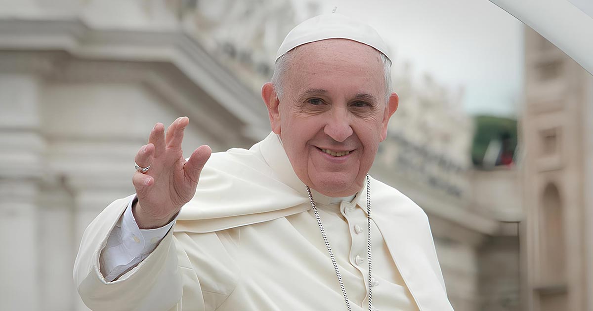 A photo of Pope Francis smiling and waving